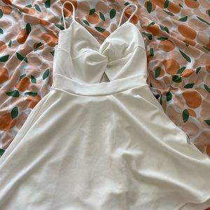 White mini dress with cutout detail and shorts underneath